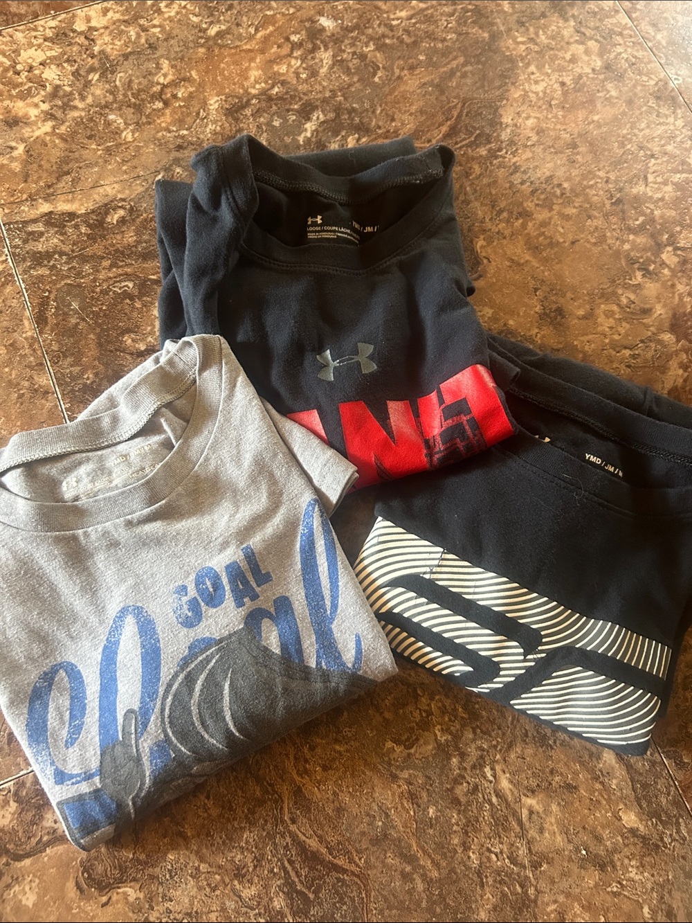 Three Under Armour youth medium tops